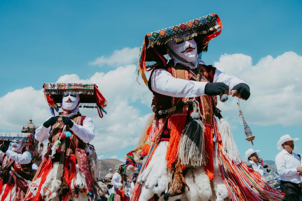 pexels-photo-22884634-22884634 Colorful traditional dancers celebrating a festival in Cusco, Peru under a bright blue sky.