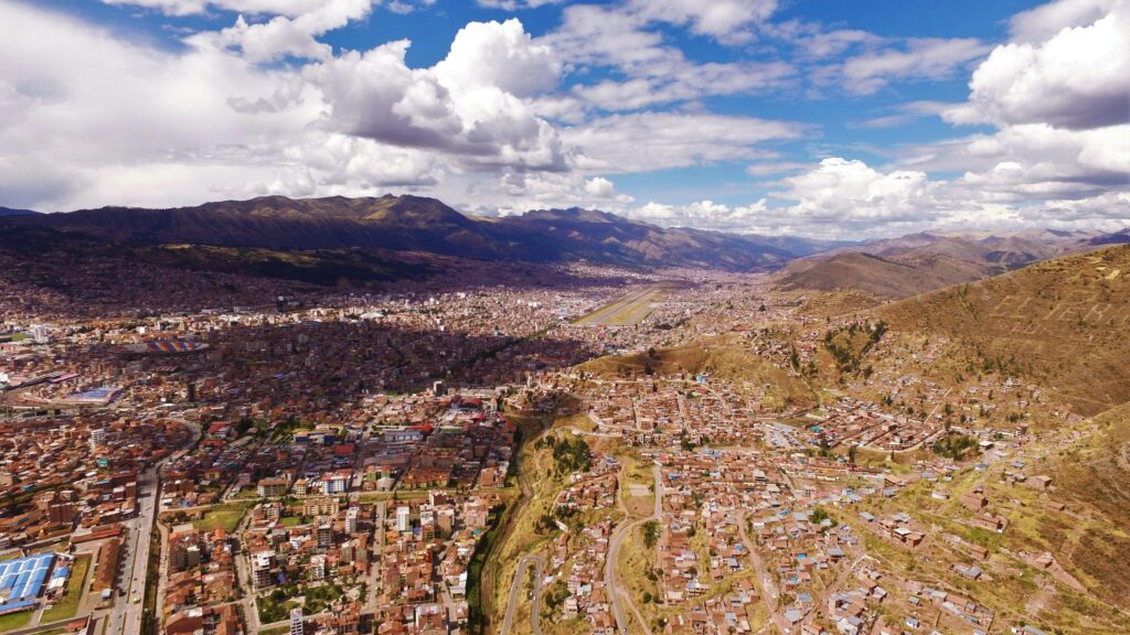 pexels-photo-102974-102974 A stunning aerial view of Cusco, Peru, showcasing urban sprawl and mountain vistas under a cloudy sky.